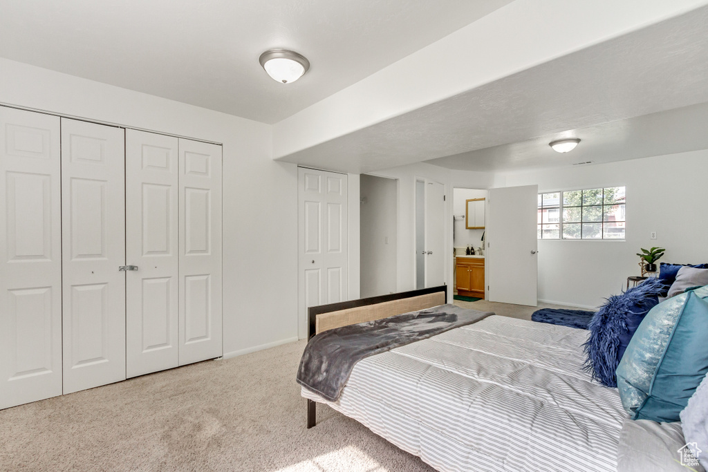 Bedroom with carpet, a closet, and baseboards