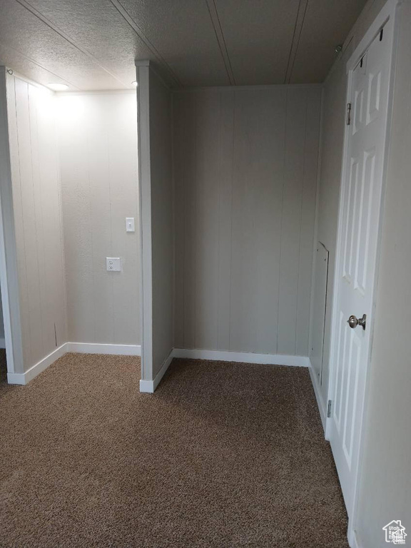 Below grade area featuring baseboards and carpet