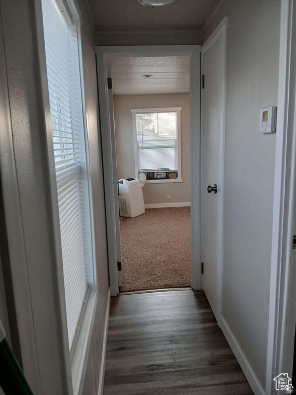 Hallway with wood finished floors and baseboards