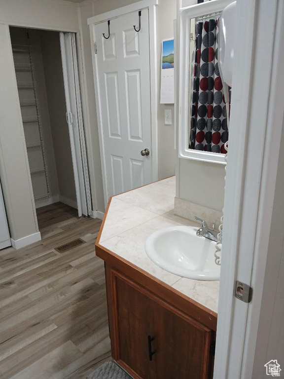 Bathroom with vanity and wood finished floors