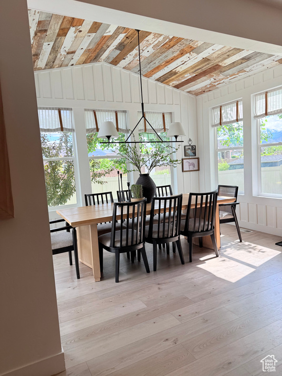 Dining room with wood-type flooring and lofted ceiling