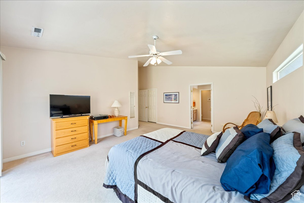 Bedroom with light carpet, lofted ceiling, baseboards, a ceiling fan, and a desk