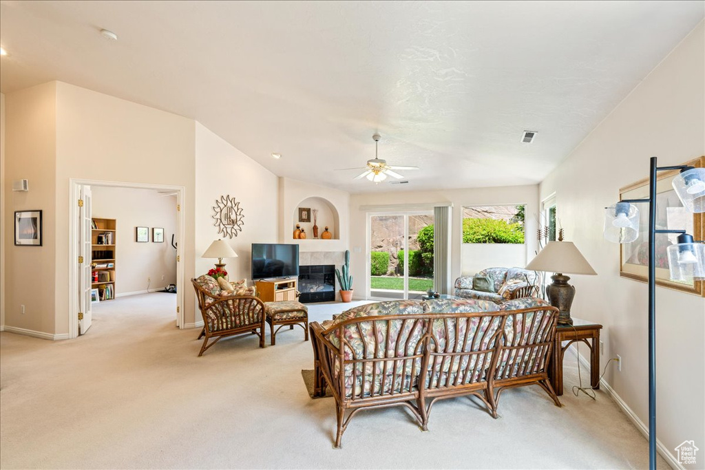 Living room featuring light carpet, a ceiling fan, and baseboards