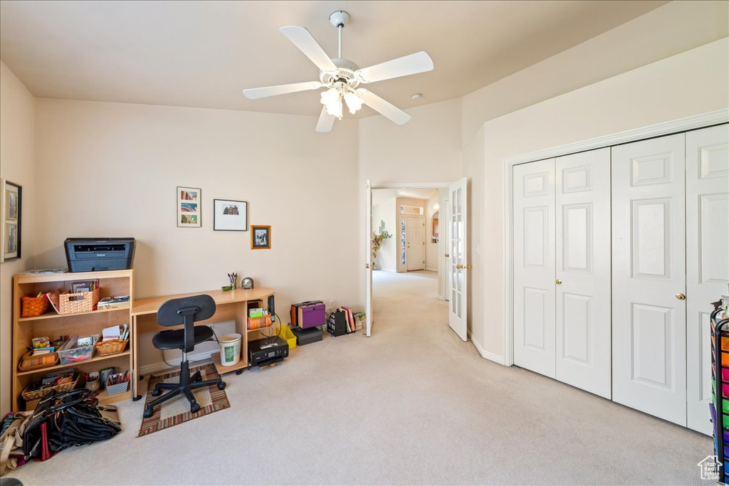Office area featuring carpet floors and ceiling fan
