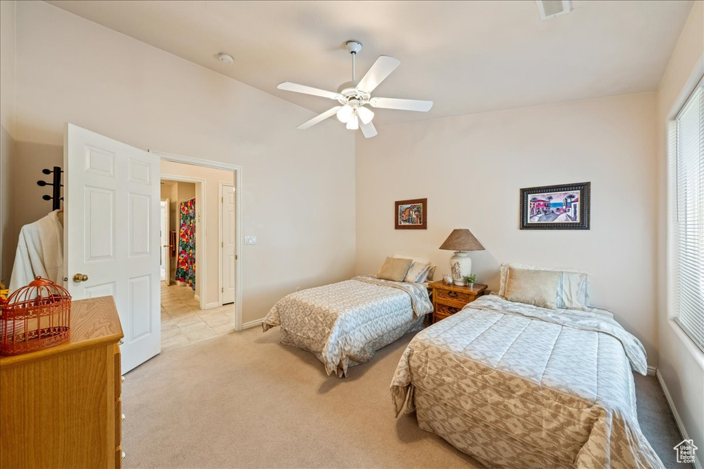 Bedroom featuring carpet flooring, a closet, a ceiling fan, baseboards, and vaulted ceiling