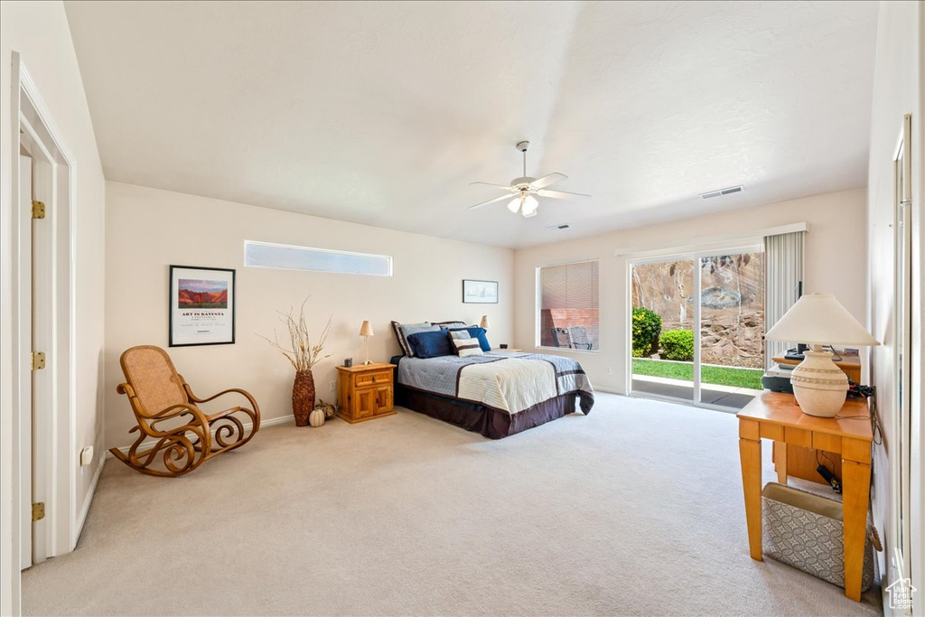 Carpeted bedroom with access to outside, multiple windows, ceiling fan, and baseboards