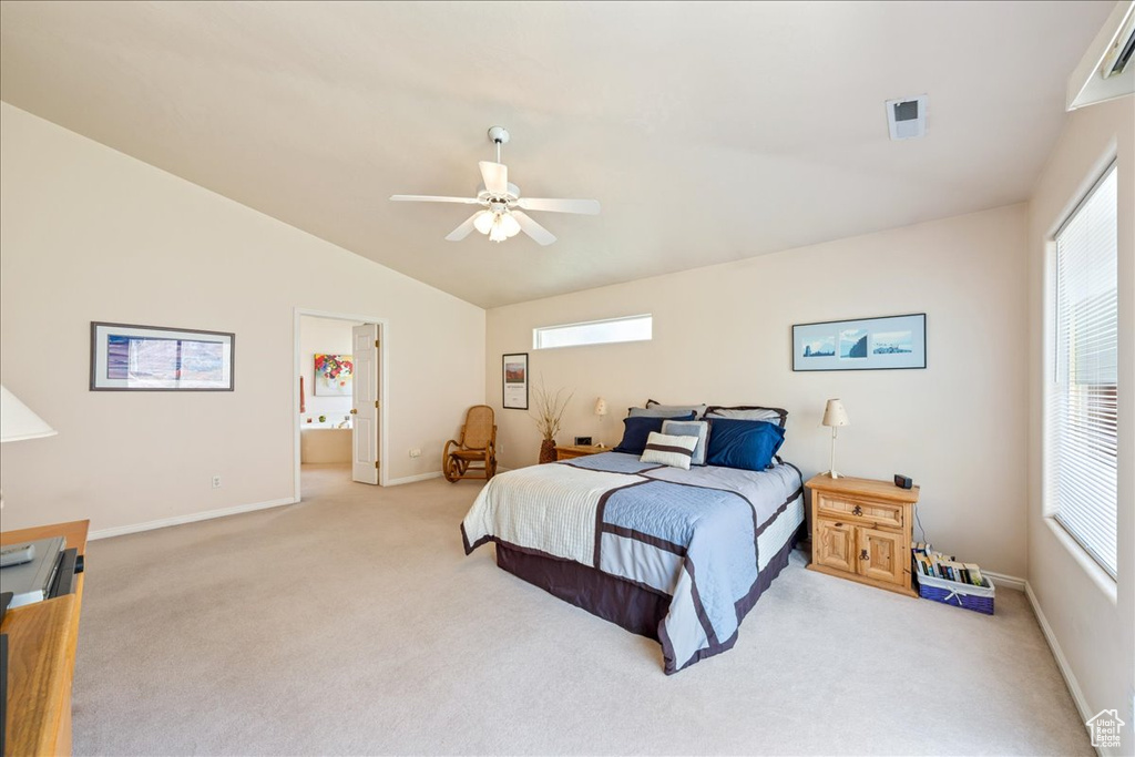 Bedroom featuring vaulted ceiling, light colored carpet, baseboards, ceiling fan, and connected bathroom