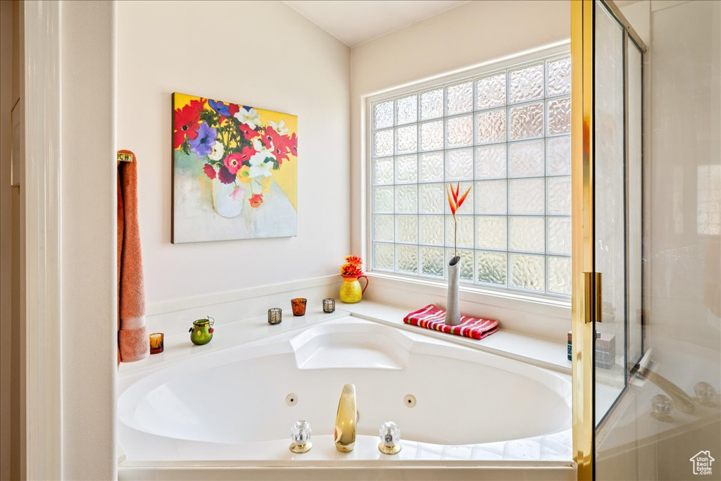 Bathroom featuring a stall shower and a jetted tub