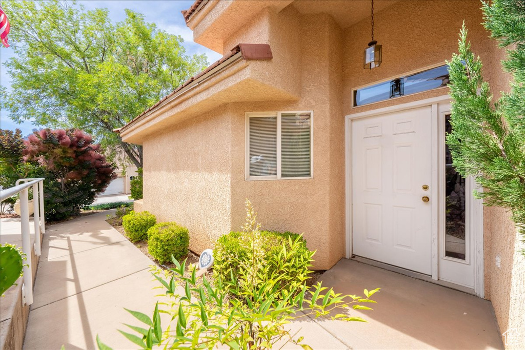 View of exterior entry featuring stucco siding