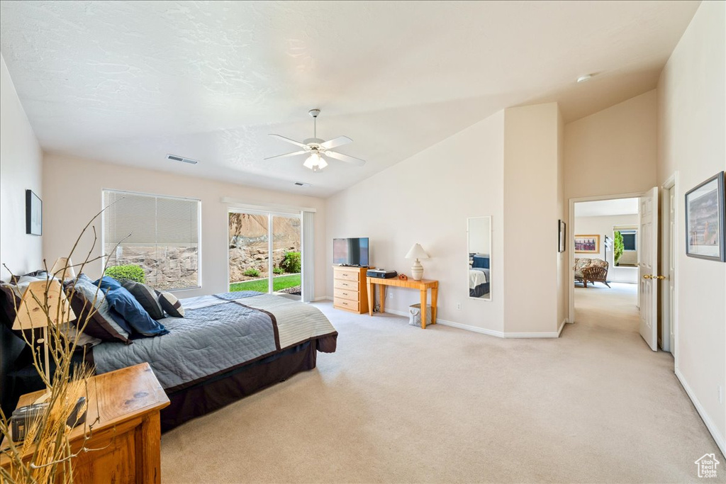 Bedroom featuring light carpet, ceiling fan, baseboards, and high vaulted ceiling