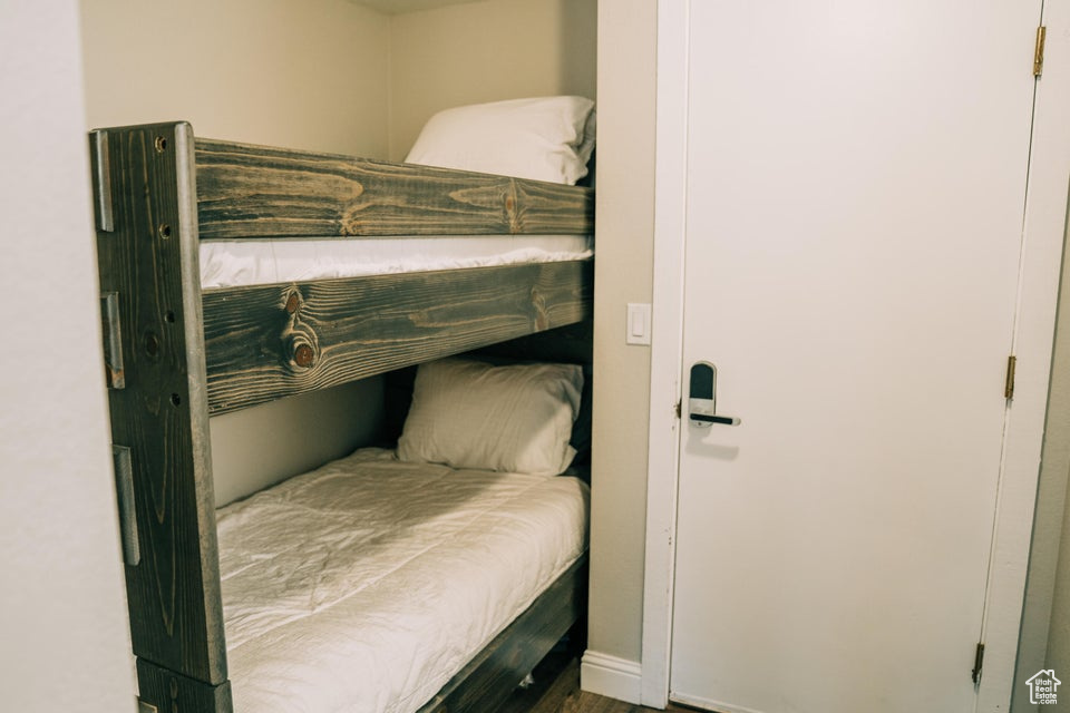 Bedroom featuring baseboards and wood finished floors