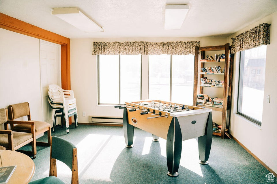 Rec room featuring baseboard heating and baseboards