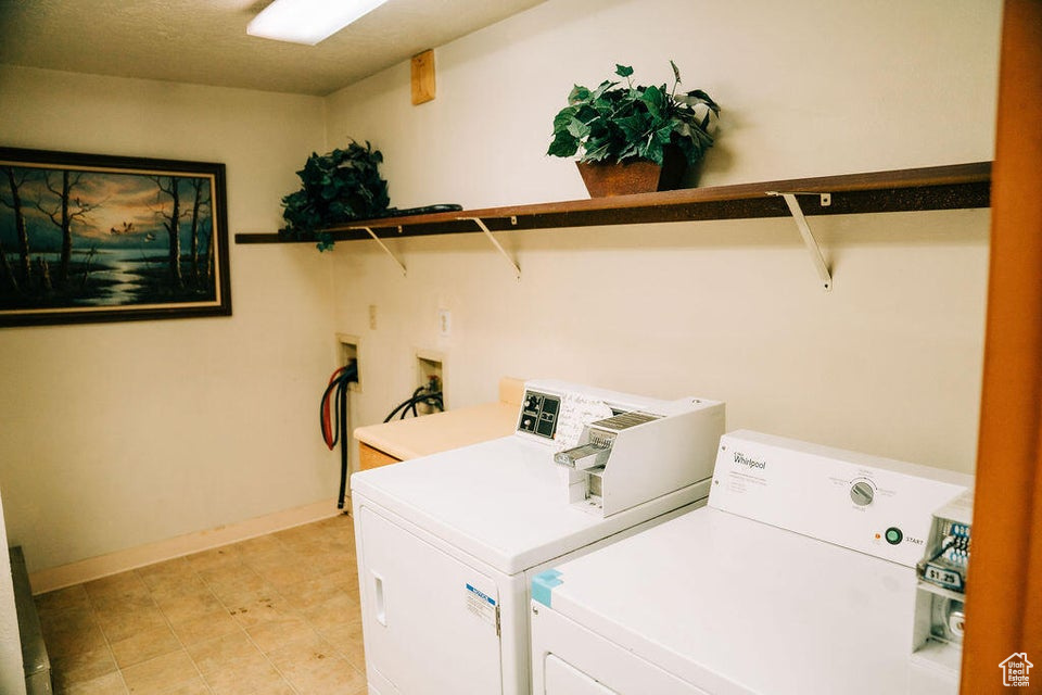 Laundry room featuring independent washer and dryer and baseboards