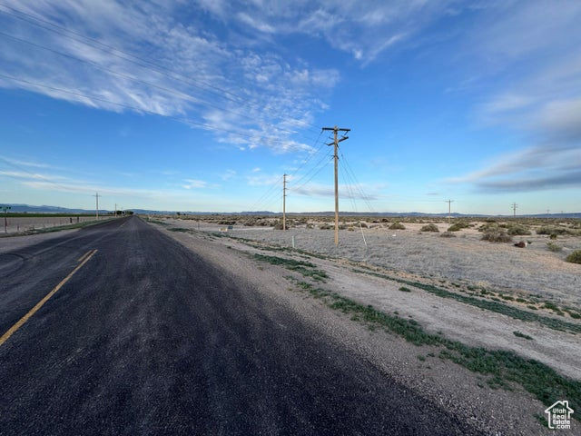 View of asphalt road featuring a view of rural / pastoral area