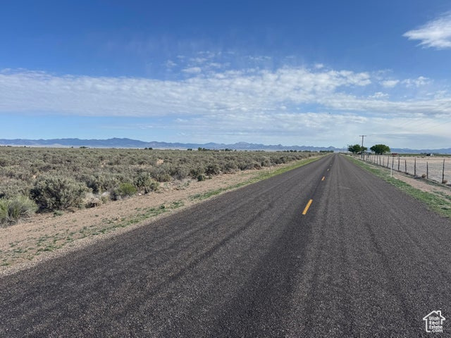 View of asphalt street with a rural view and a mountain view
