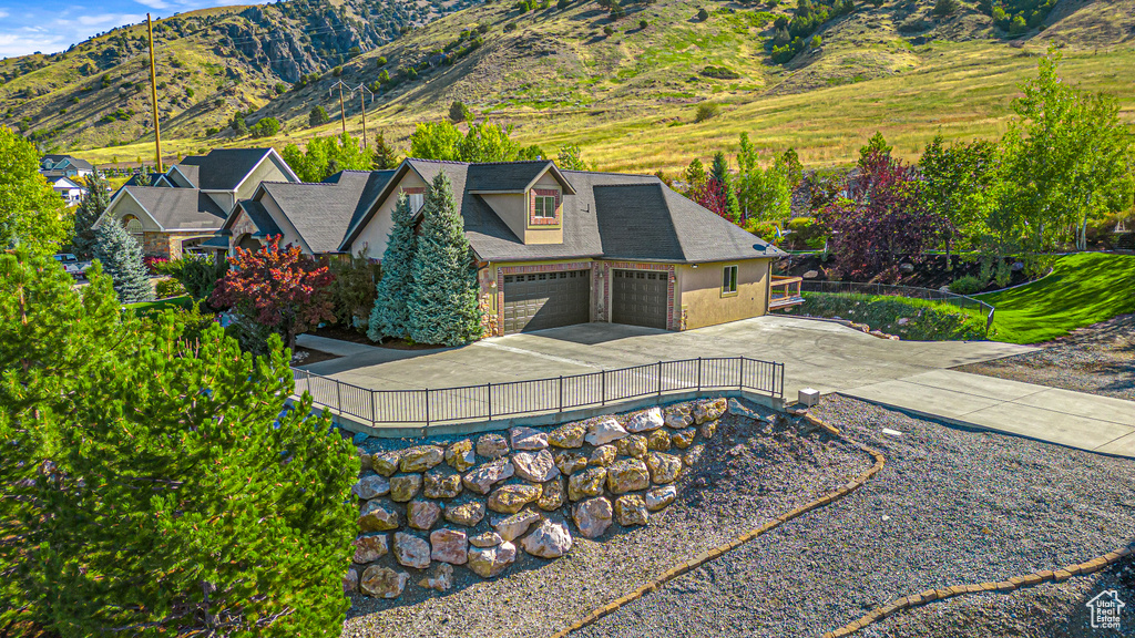 Aerial view of property and surrounding area with a mountainous background
