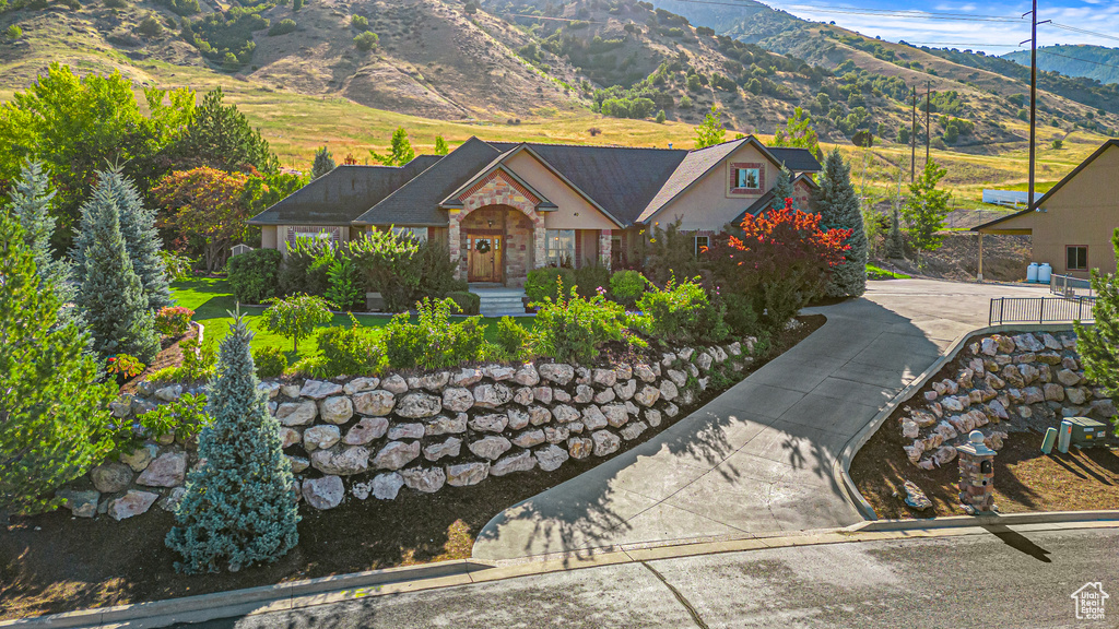 View of front facade featuring stone siding and a mountain view