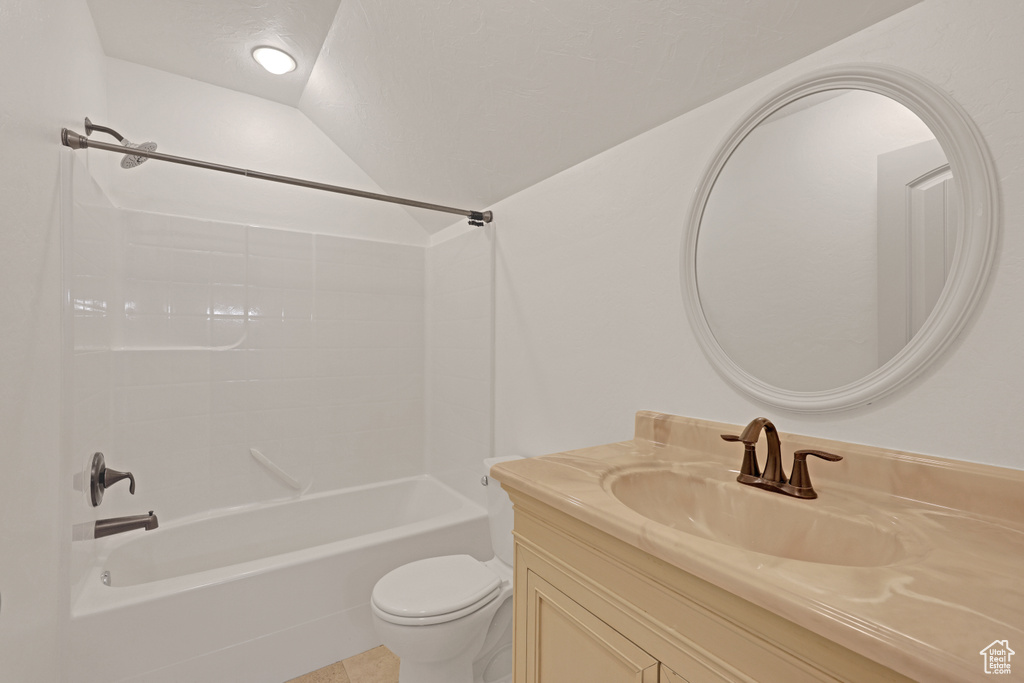 Bathroom with vanity, shower / washtub combination, toilet, and lofted ceiling