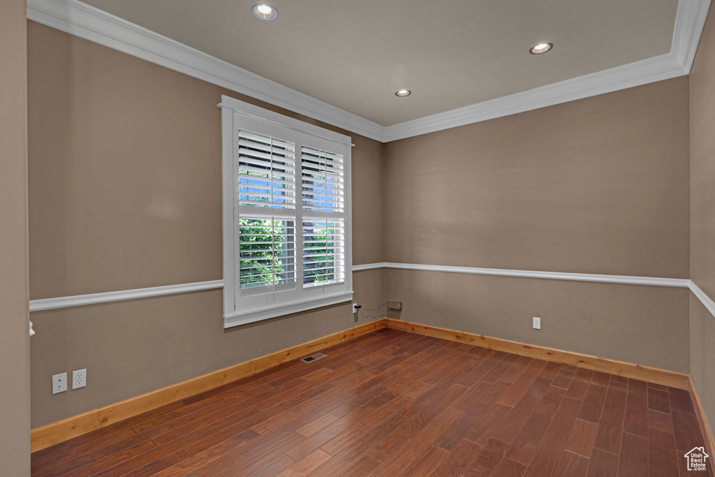 Unfurnished room with crown molding, baseboards, recessed lighting, and wood finished floors