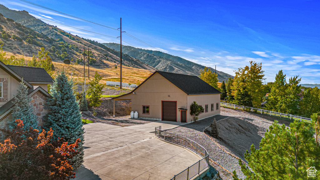 Rear view of property featuring a mountain view and a detached garage