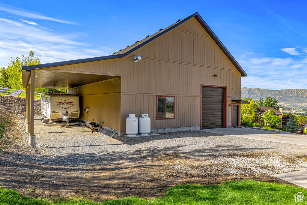 View of outbuilding featuring a mountain view and a garage