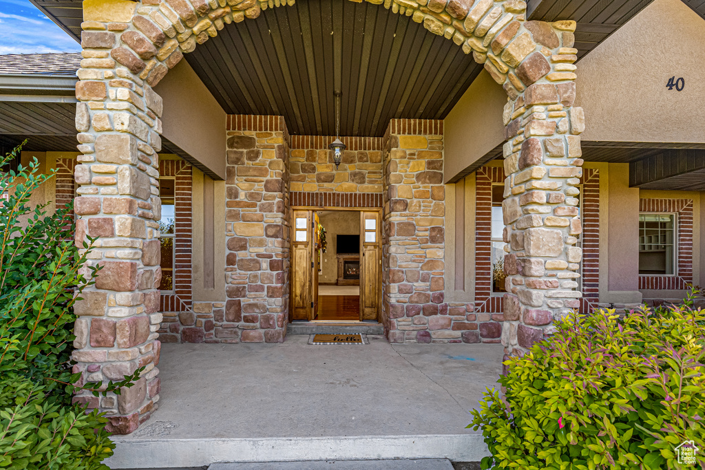 Entrance to property featuring stone siding and stucco siding