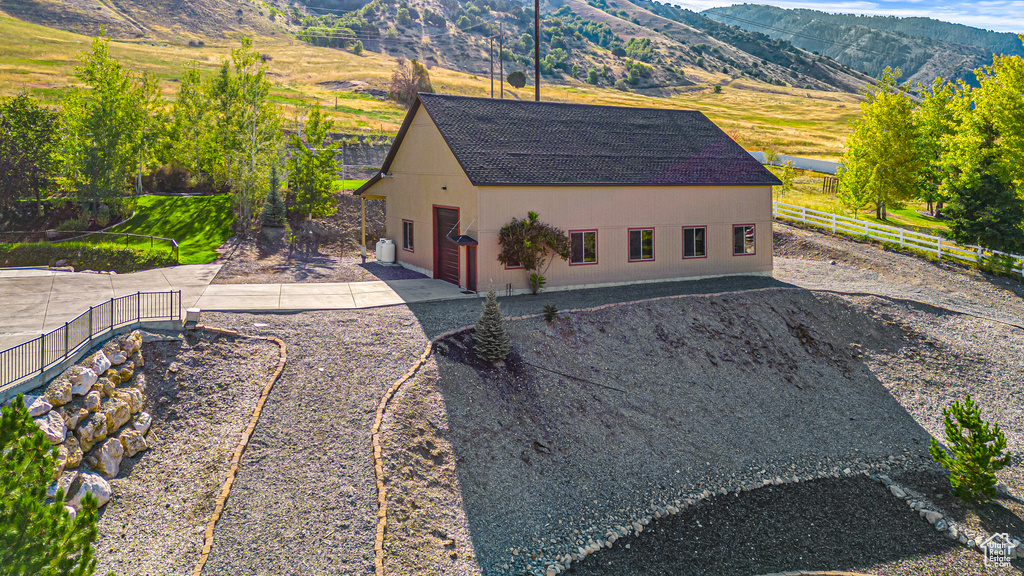 Aerial view of property and surrounding area with a mountain backdrop