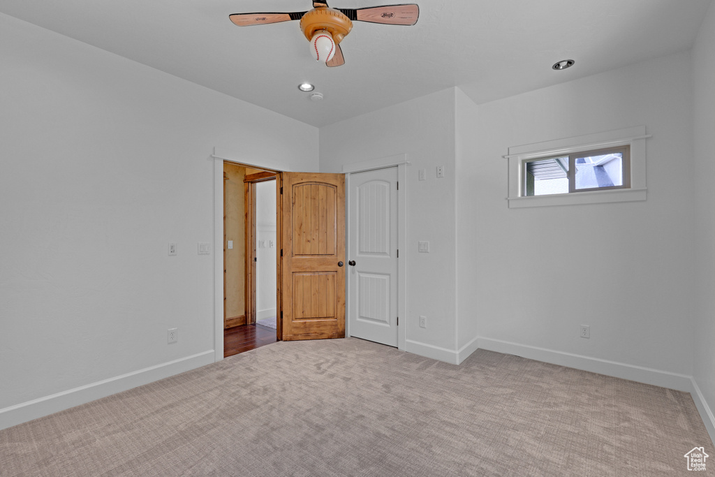 Unfurnished bedroom featuring carpet floors, baseboards, ceiling fan, and recessed lighting