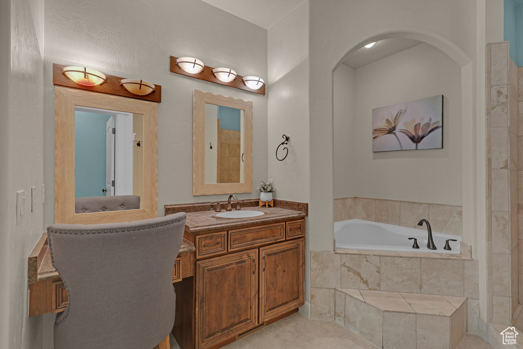 Full bathroom featuring a bath and vanity