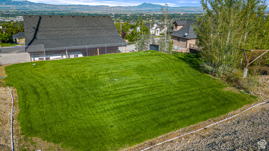 Aerial perspective of suburban area featuring a mountainous background