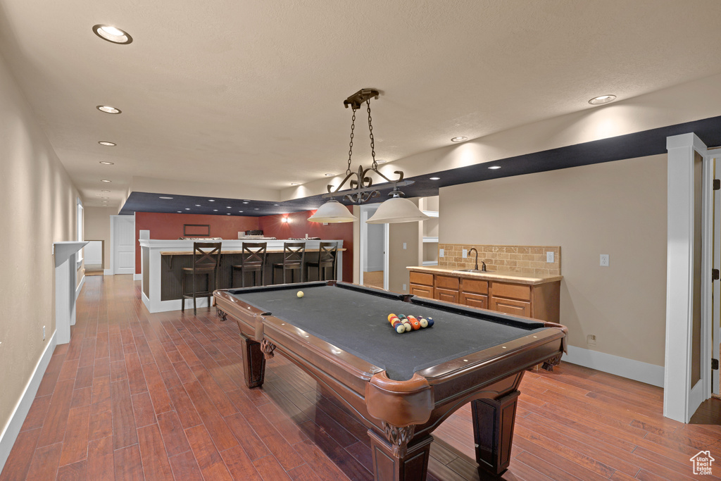 Game room with wet bar, baseboards, dark wood-style flooring, recessed lighting, and pool table