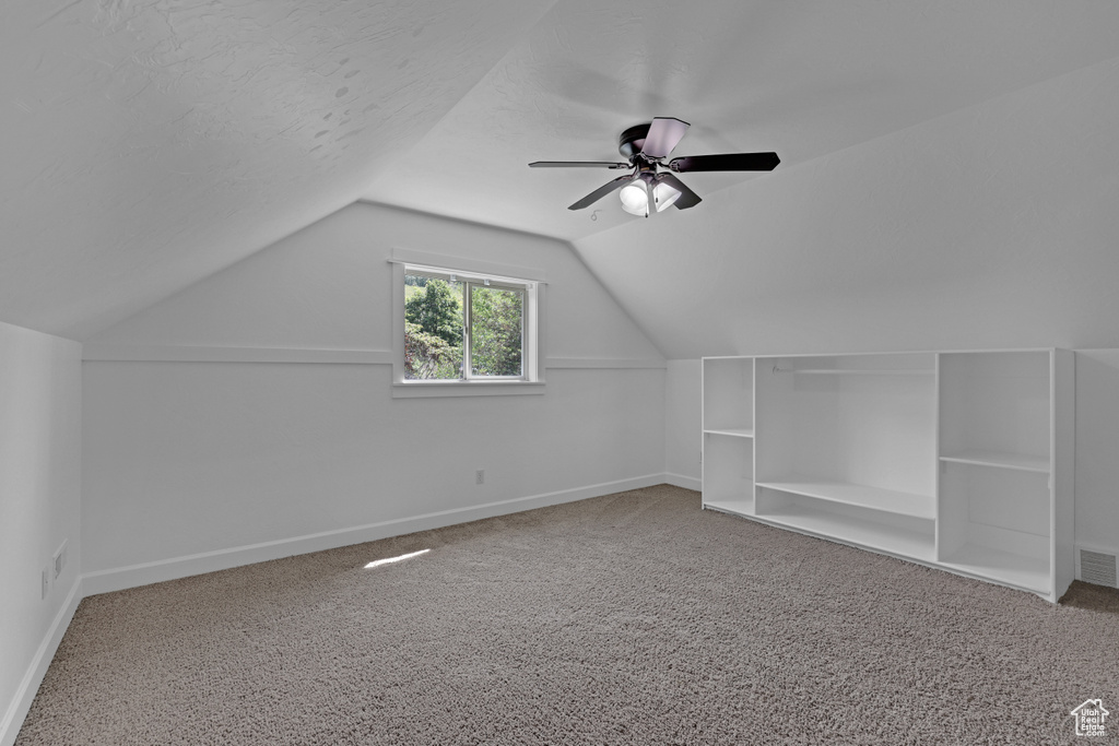 Bonus room with carpet, lofted ceiling, and baseboards