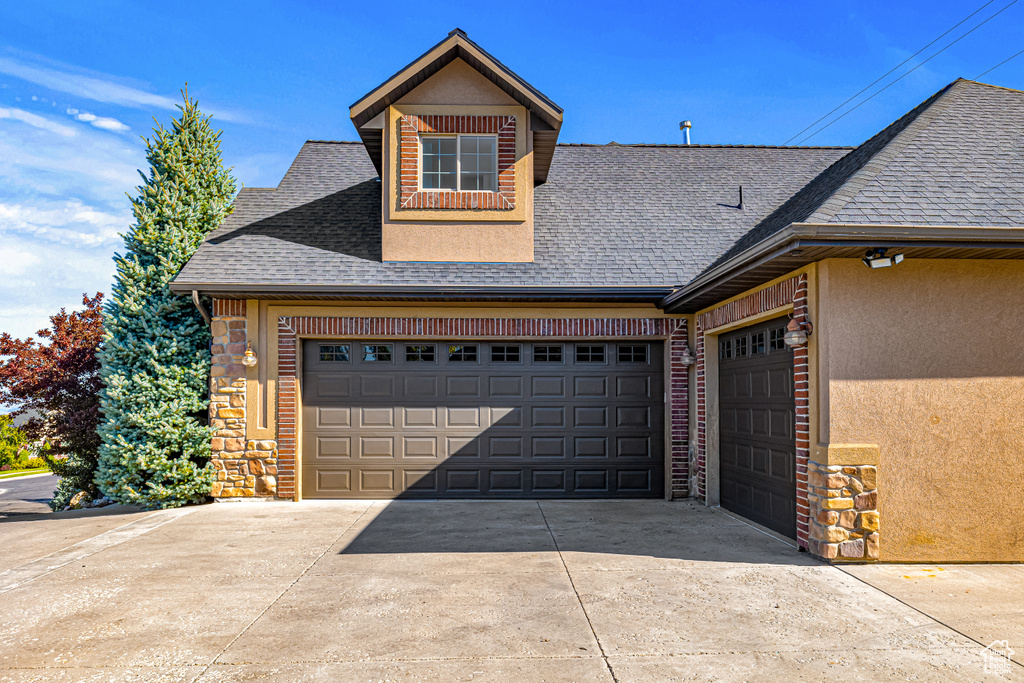 Garage featuring concrete driveway