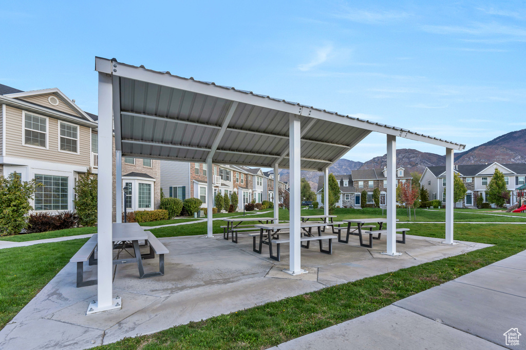Surrounding community with a lawn, a residential view, a mountain view, and a gazebo
