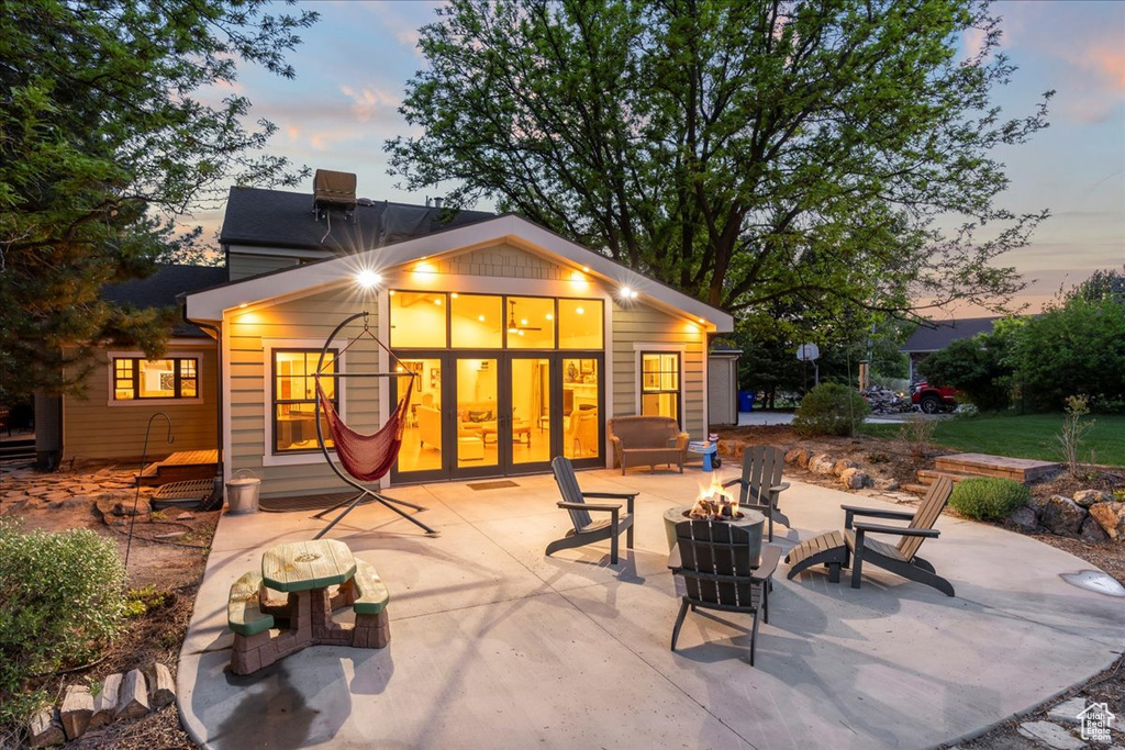 Back of house featuring an outdoor fire pit and a patio