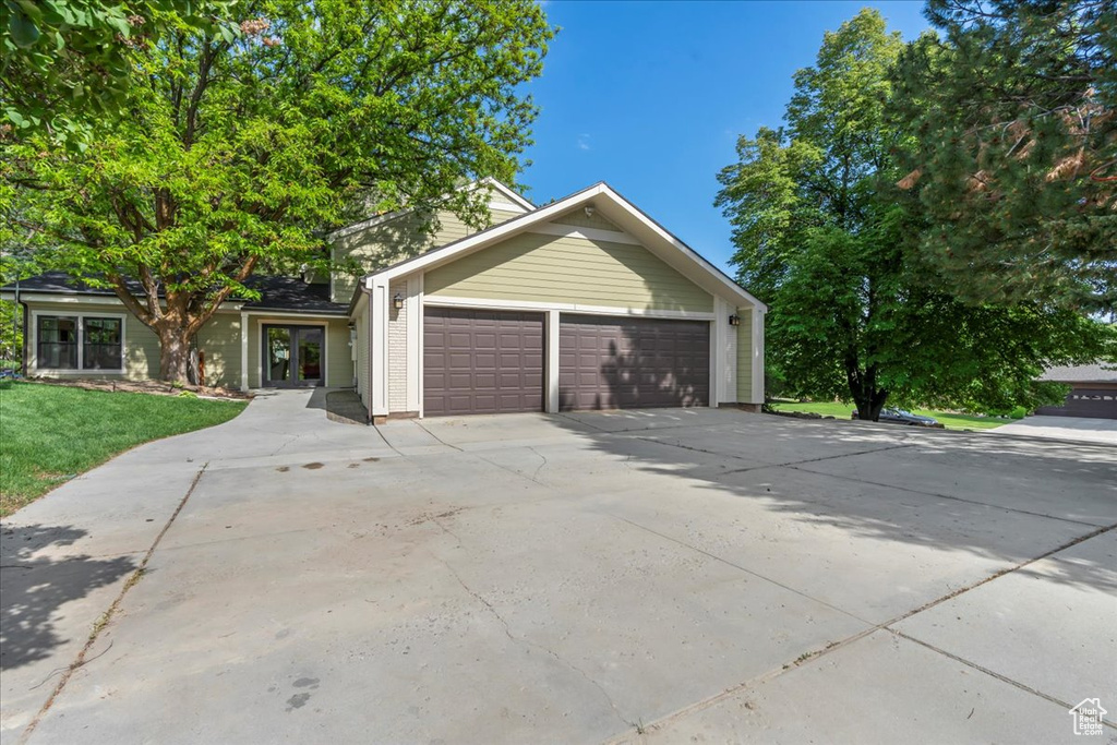 View of front facade featuring a garage and concrete driveway