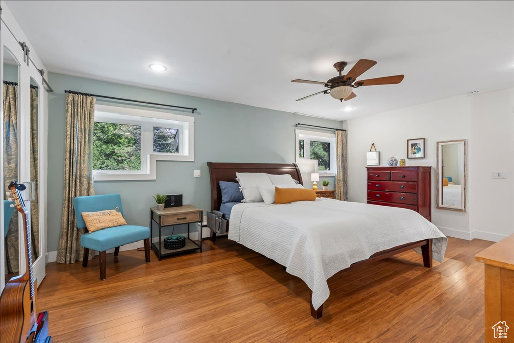 Bedroom featuring multiple windows, light wood-style flooring, recessed lighting, a ceiling fan, and baseboards