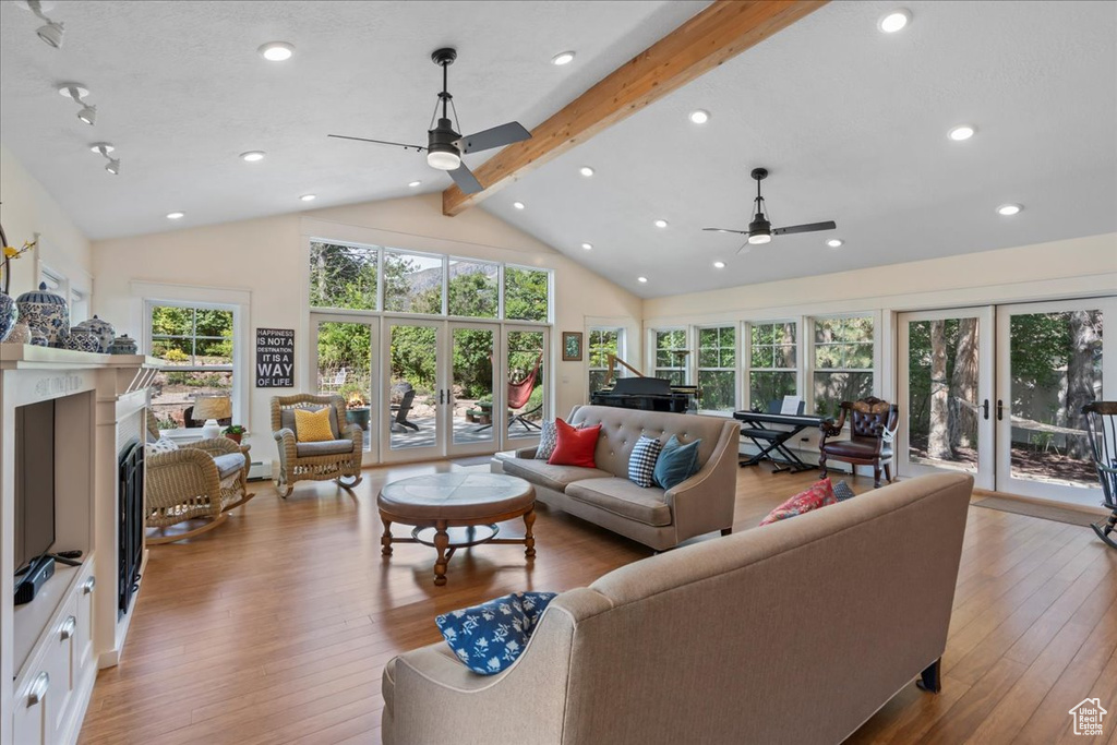 Living room featuring ceiling fan, beamed ceiling, plenty of natural light, hardwood / wood-style floors, and recessed lighting
