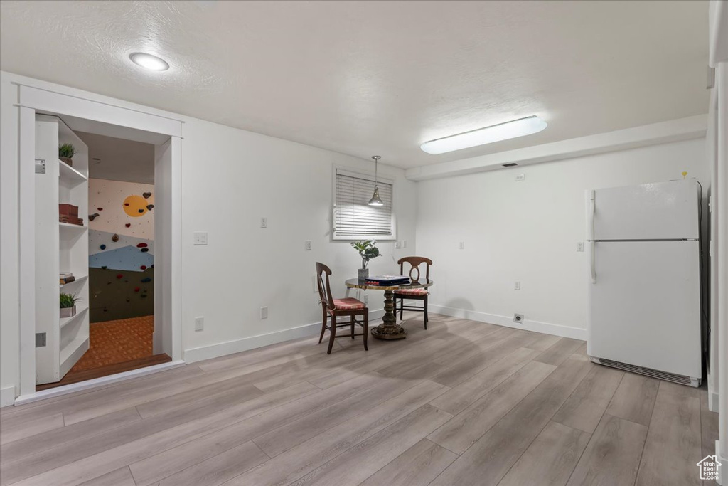 Dining space with light wood-type flooring and baseboards