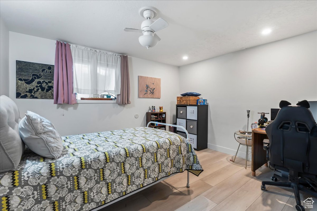 Bedroom with wood finished floors, an office area, a ceiling fan, and recessed lighting