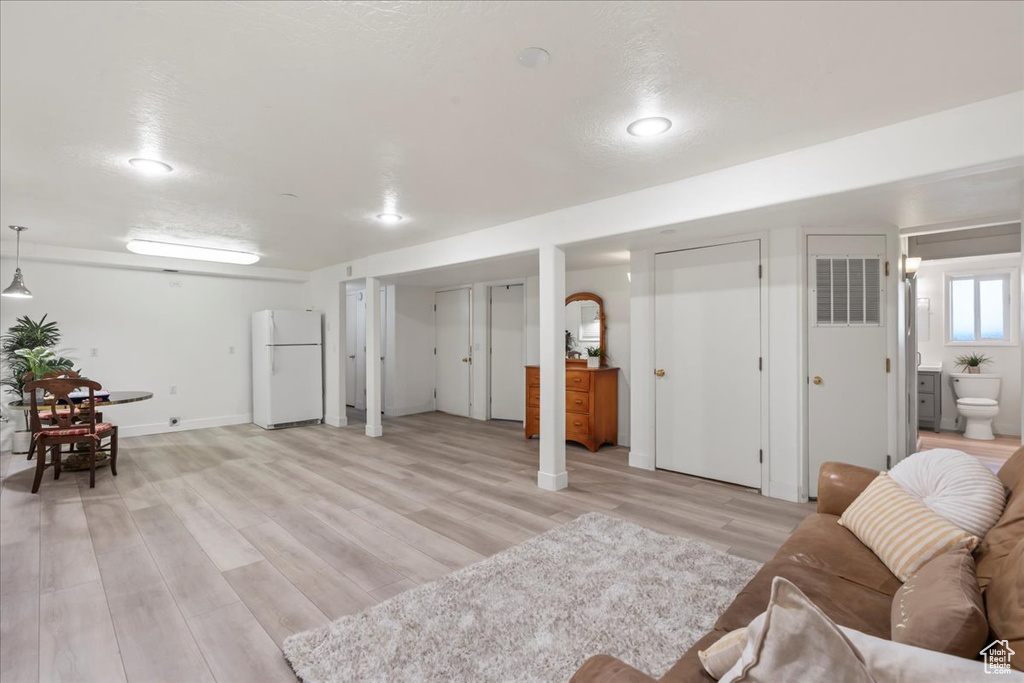 Living area featuring light wood-style floors and recessed lighting