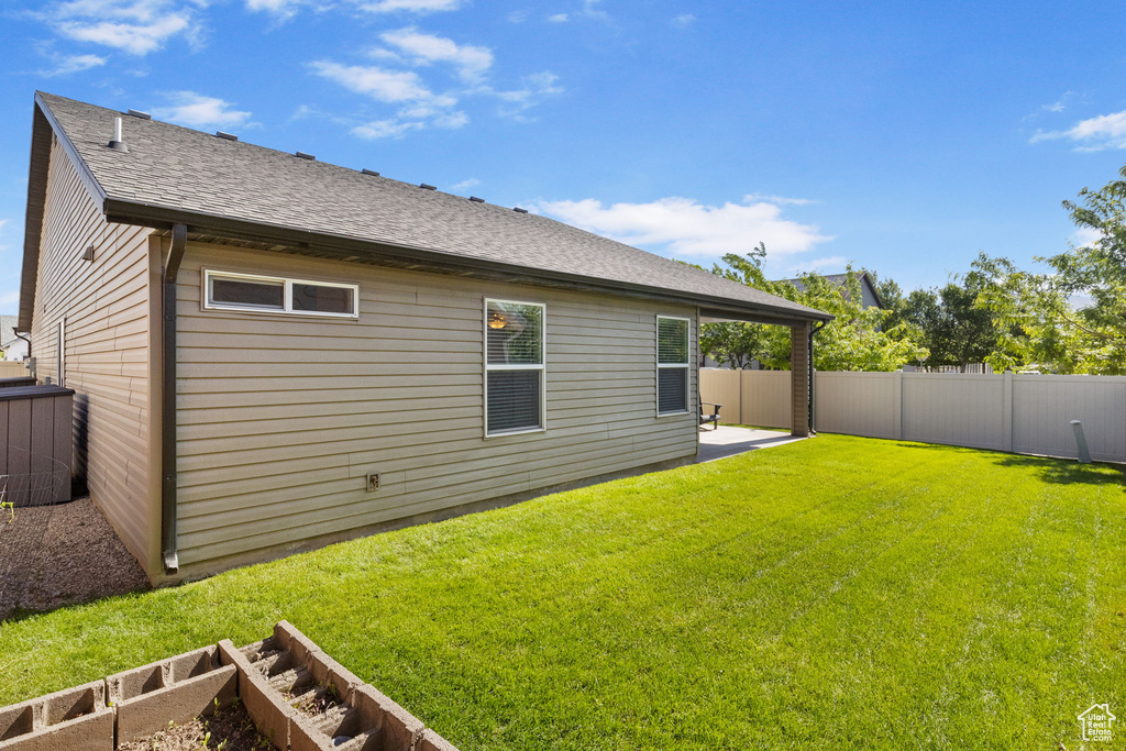 Back of property featuring a patio area and roof with shingles