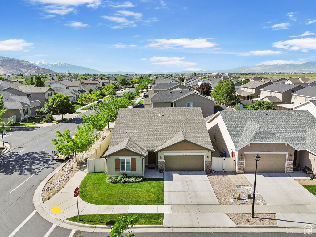 Aerial perspective of suburban area featuring a mountain backdrop