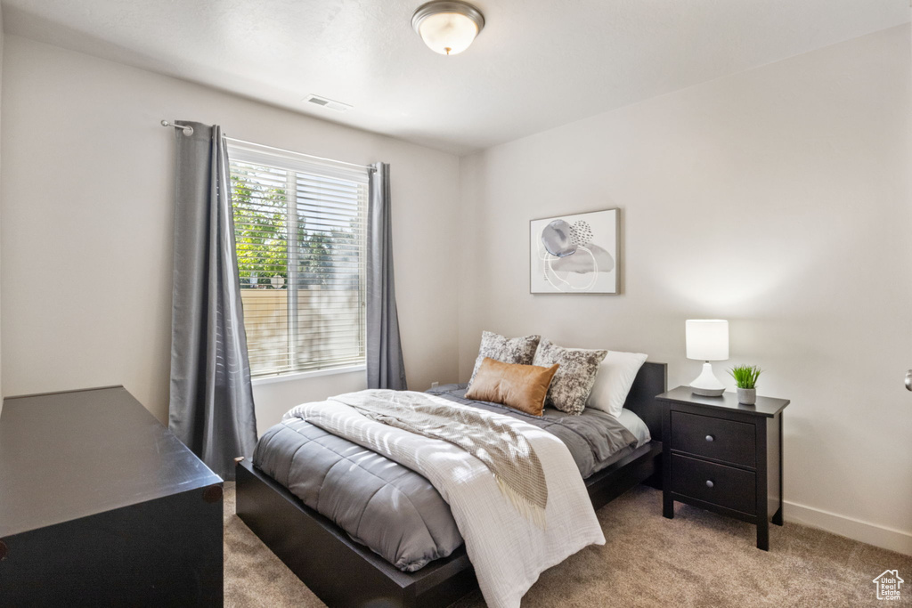Carpeted bedroom featuring baseboards