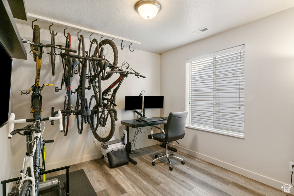 Office with wood finished floors and baseboards