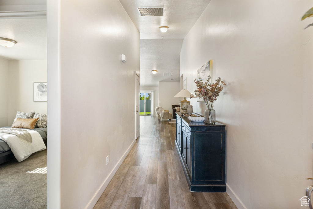 Corridor with wood finished floors and baseboards