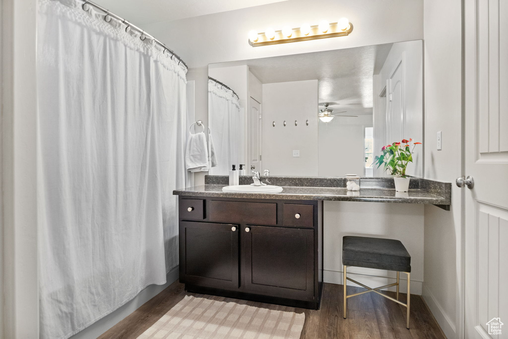 Bathroom featuring wood finished floors, vanity, and ceiling fan