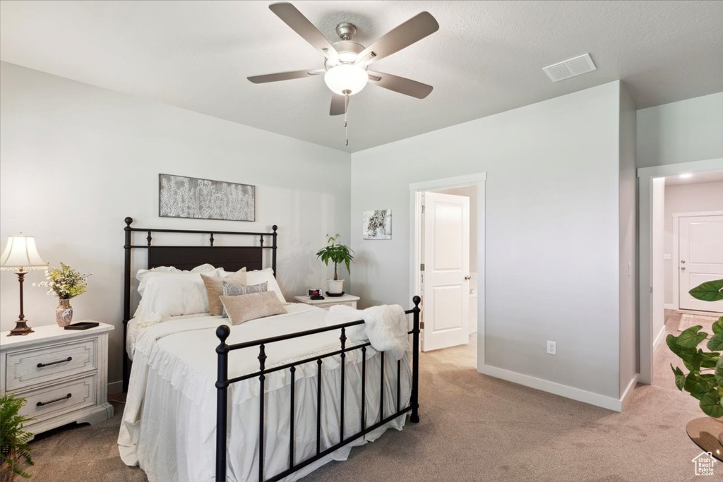 Bedroom with carpet floors, baseboards, and a ceiling fan