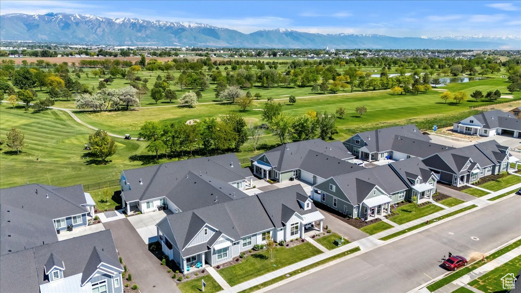 Aerial view of residential area with a local golf course and a water and mountain view