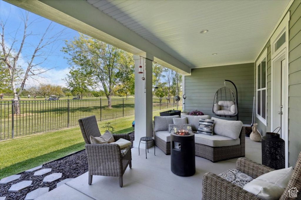 View of patio with an outdoor living space with a fire pit